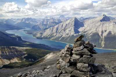 Panoramic Kananaskis view of towering mountains and a winding lake—adventure awaits-