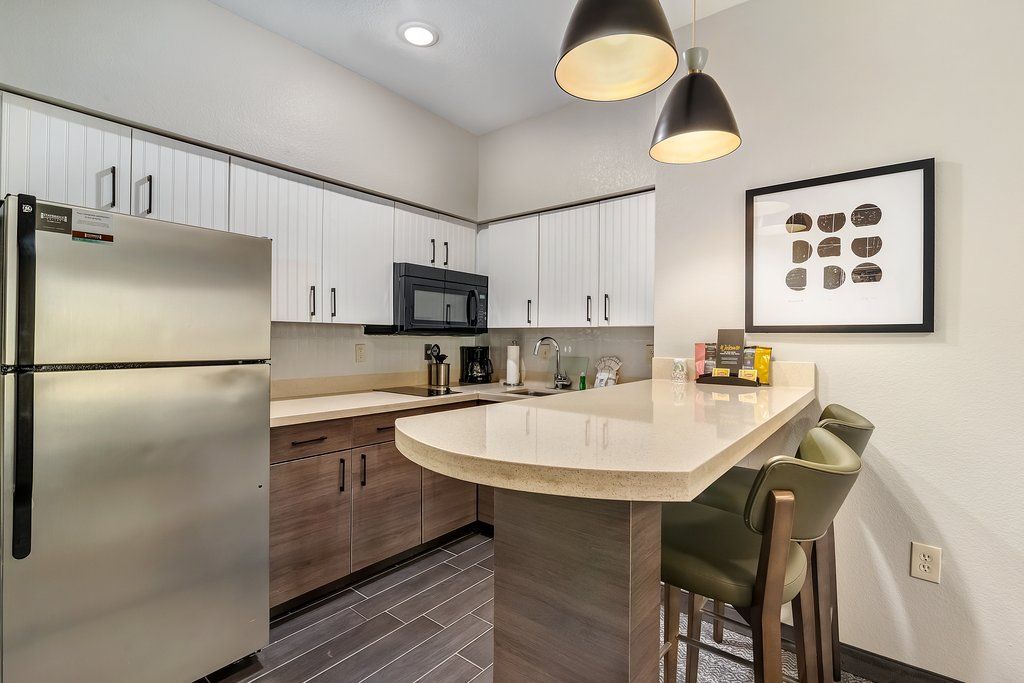 image Relax at the kitchen bar with contemporary seating, perfect for enjoying coffee or a casual meal.