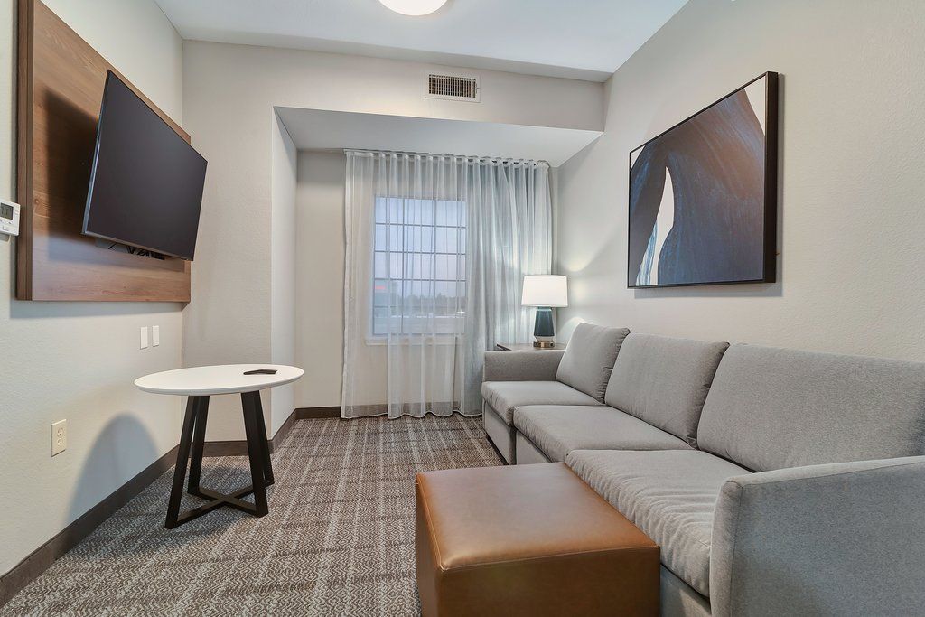 image Experience restful moments in this airy living space, furnished with inviting seating and a large flat-screen TV.