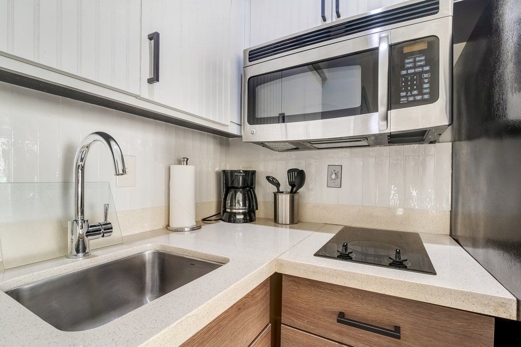 image Craft your favorite meals in this modern kitchen, complete with sleek appliances and ample counter space.