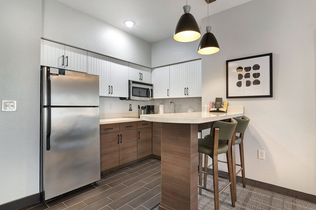 image Whip up your favorite meals in a stylish kitchen featuring modern appliances and sleek countertops.