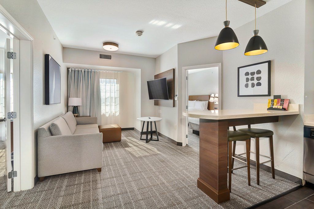 image Relax in the spacious living area, complete with plush seating and a flat-screen TV.