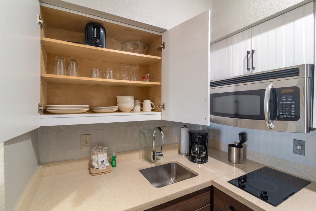 image Discover a well-organized kitchen, ready for your culinary adventures with charming glassware and essentials.