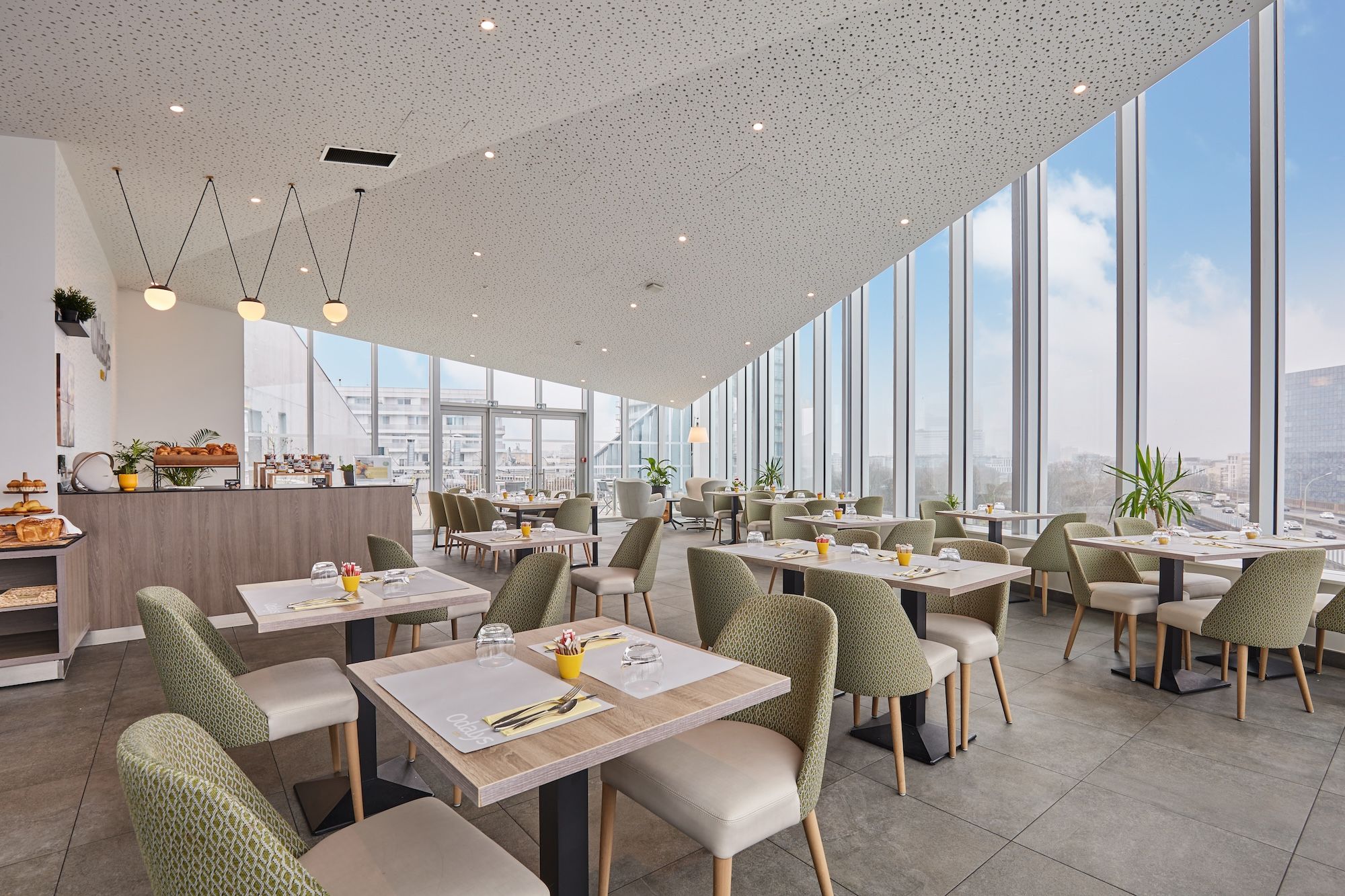 image Elevated breakfast area with city views—floor-to-ceiling windows create an airy, light-filled setting.
