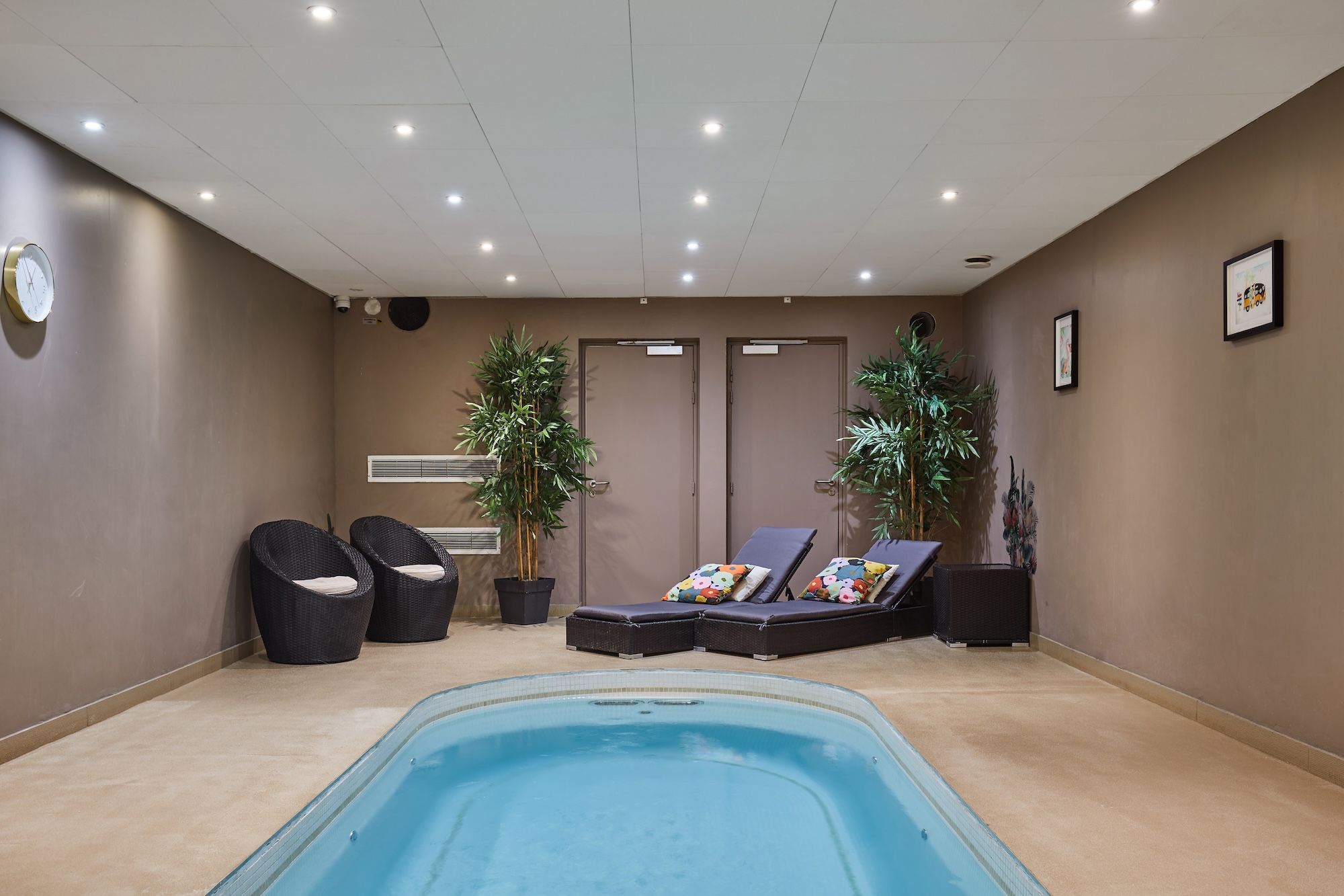 image Relaxing shared spa zone with a small pool and steam room, accessible on-site at the residence.