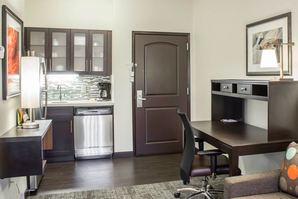 image Create a comfortable workspace alongside your kitchen, featuring a sleek desk and ergonomic chair perfect for productivity during your stay.