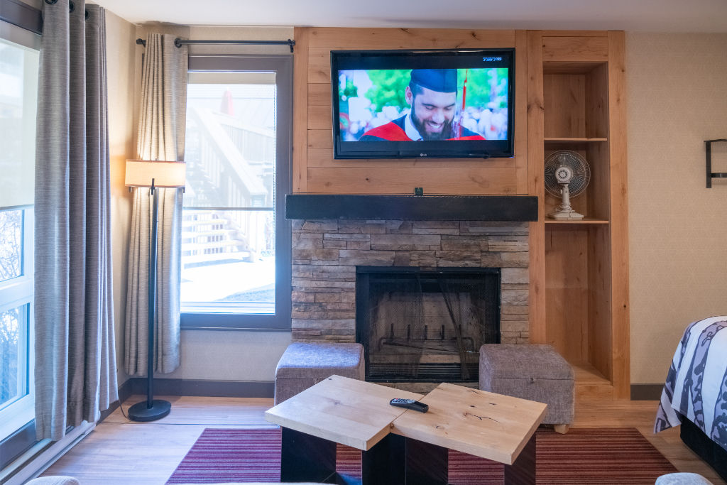 image A living room with a fireplace and entertainment system