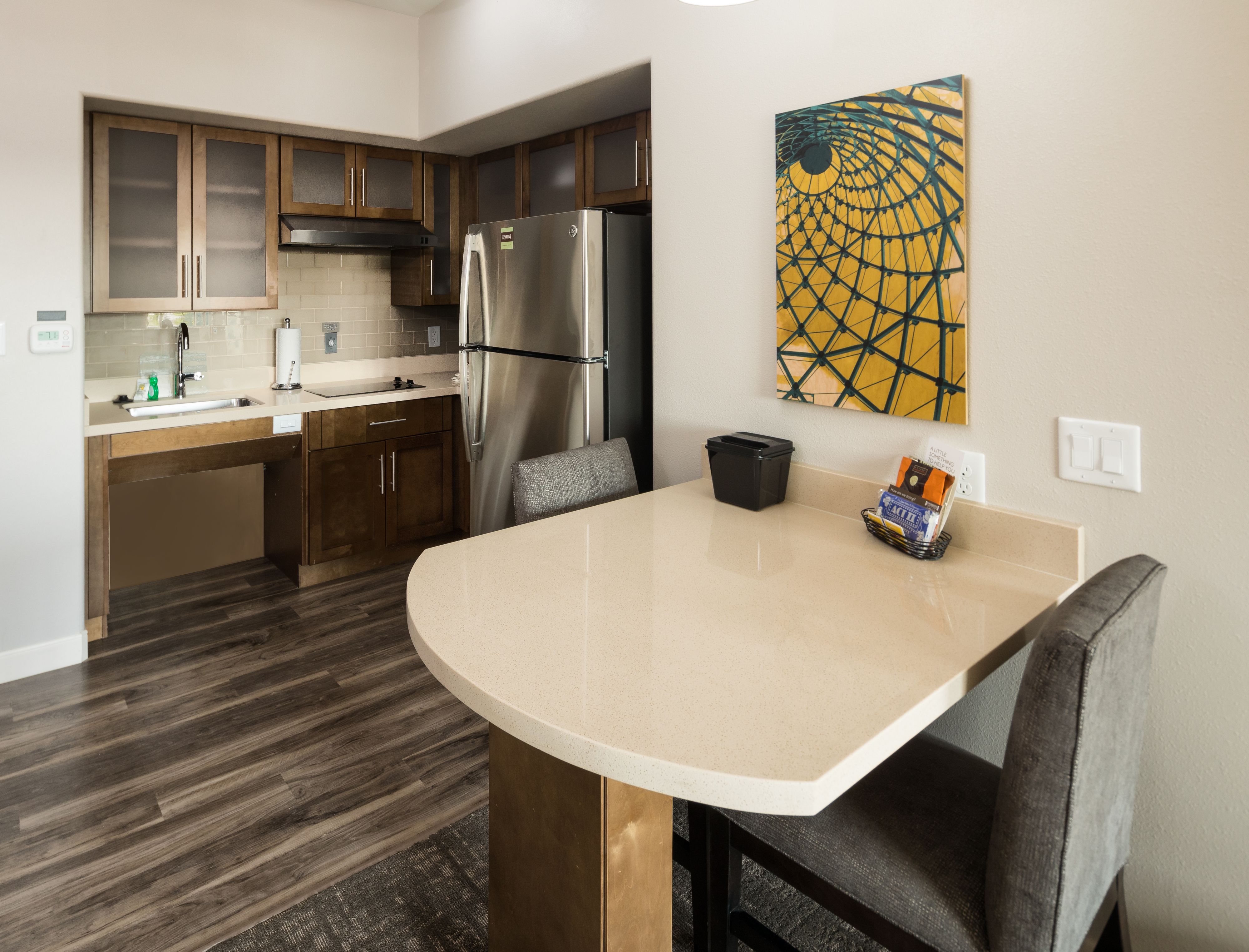 image Modern kitchen with stainless steel appliances and a breakfast bar.