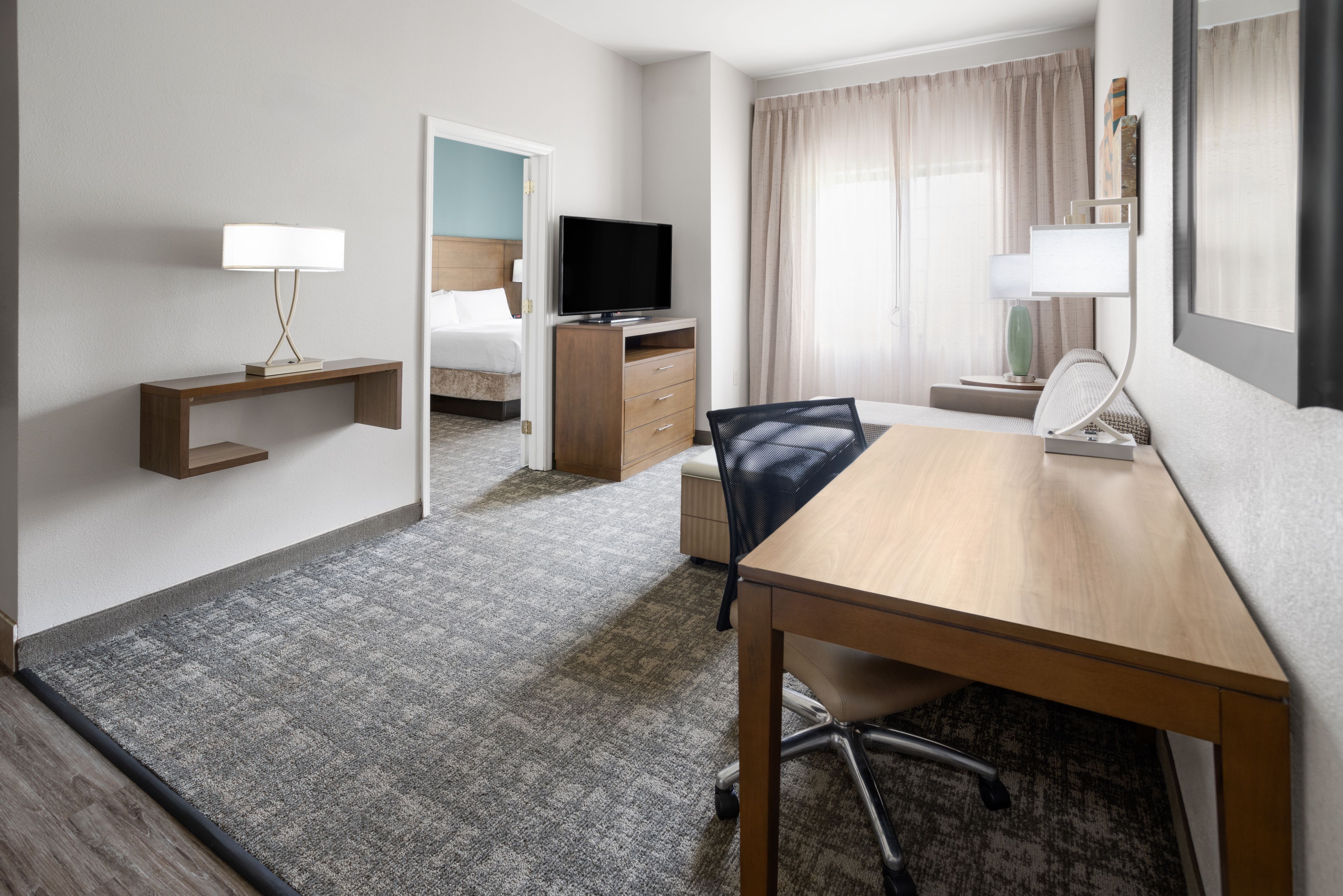 image Spacious living area with modern furnishings and natural light.