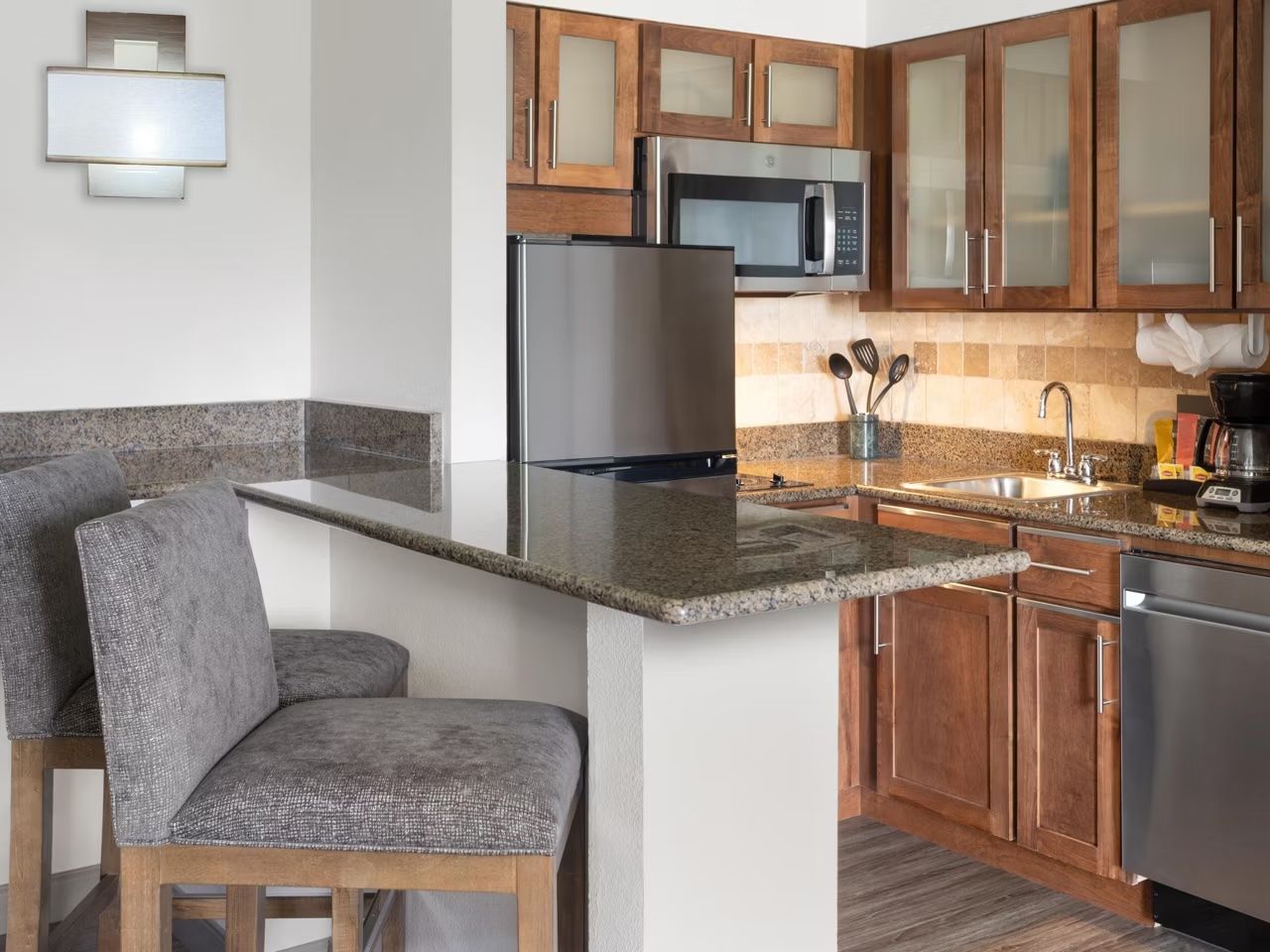 image Fully equipped kitchen with modern appliances and a dining bar that seats two