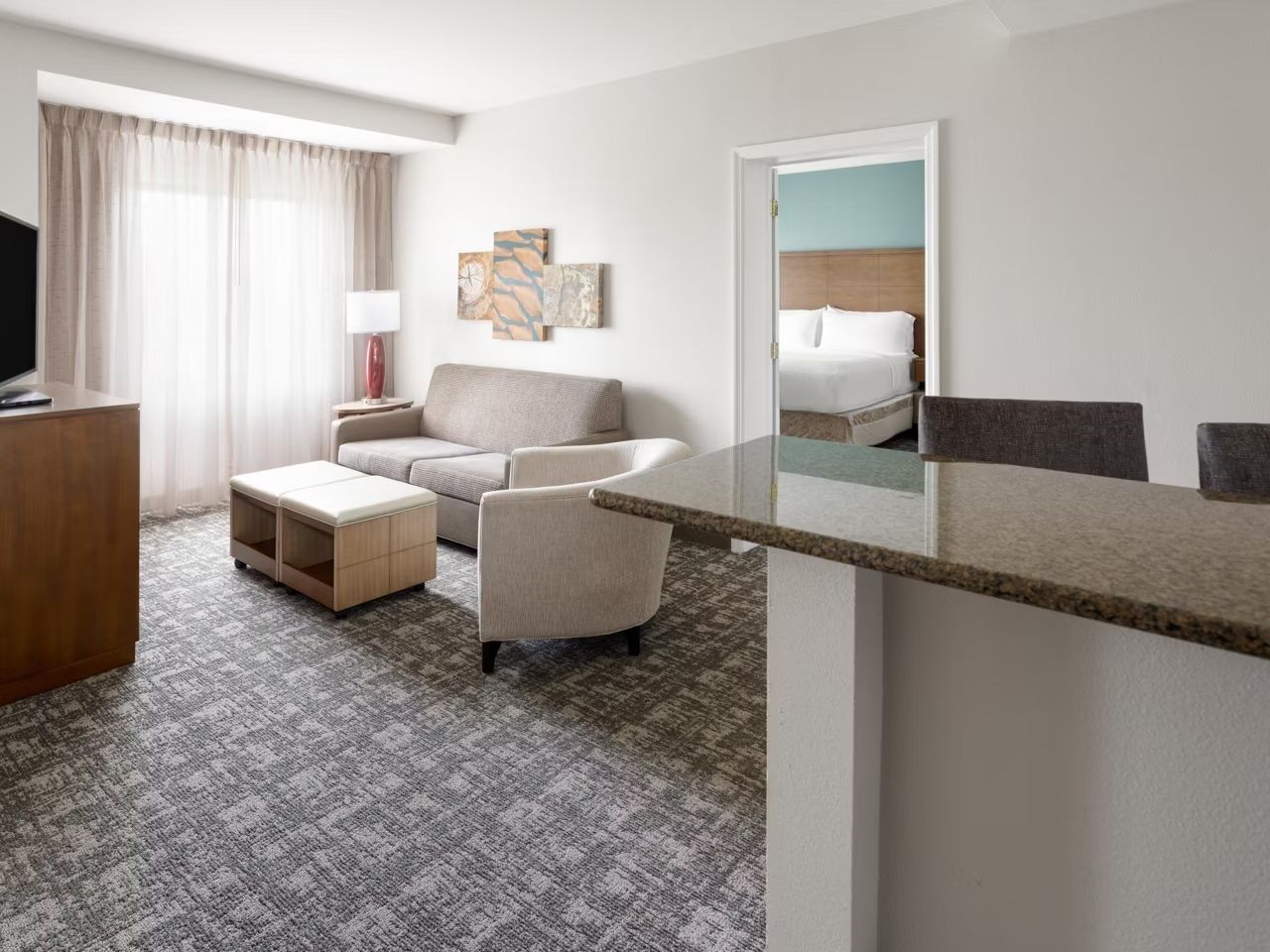 image Airy living area with large windows and comfortable seating — catch a movie or unwind after a day at Hersheypark