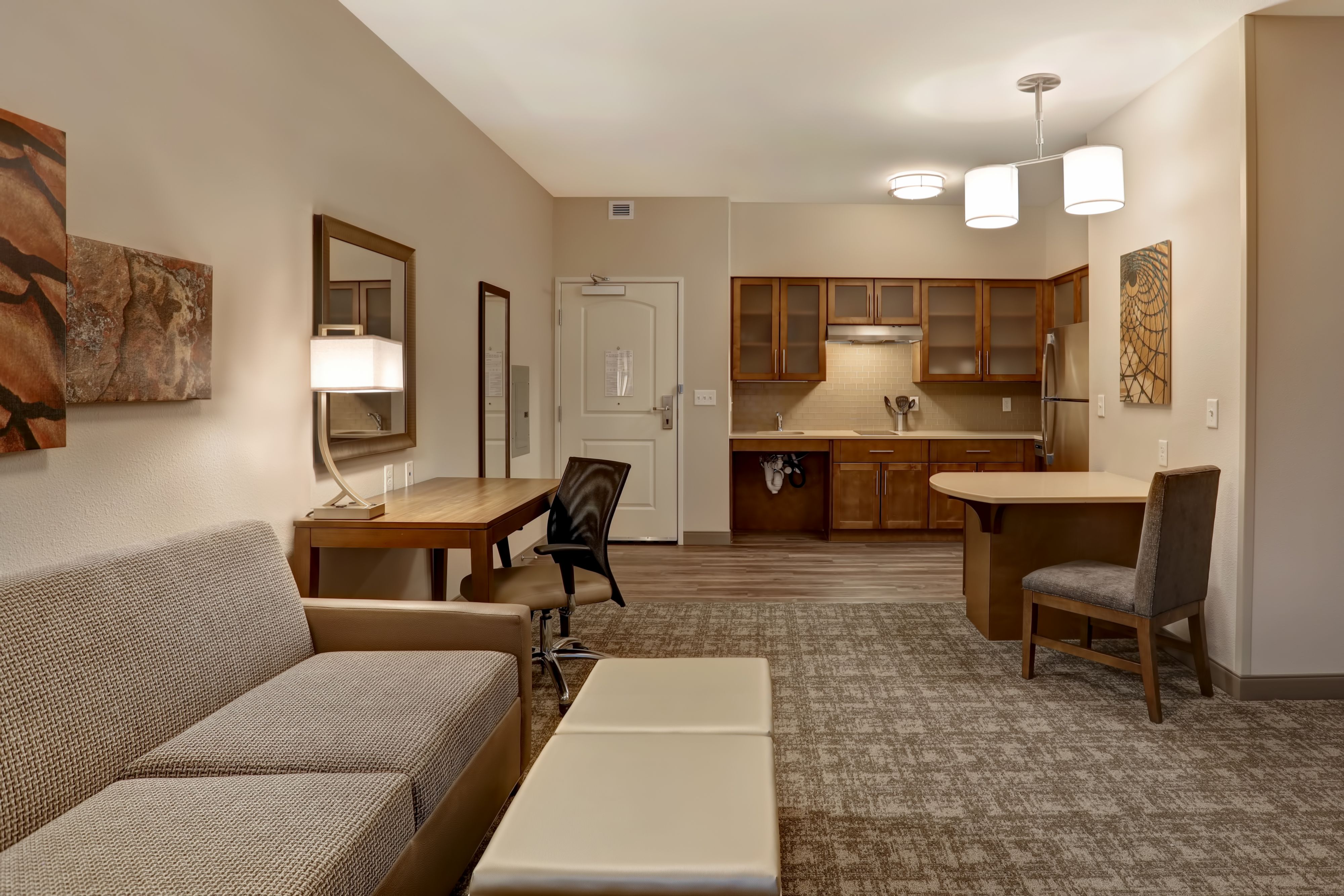 image Spacious living area with kitchenette and stylish furnishings.