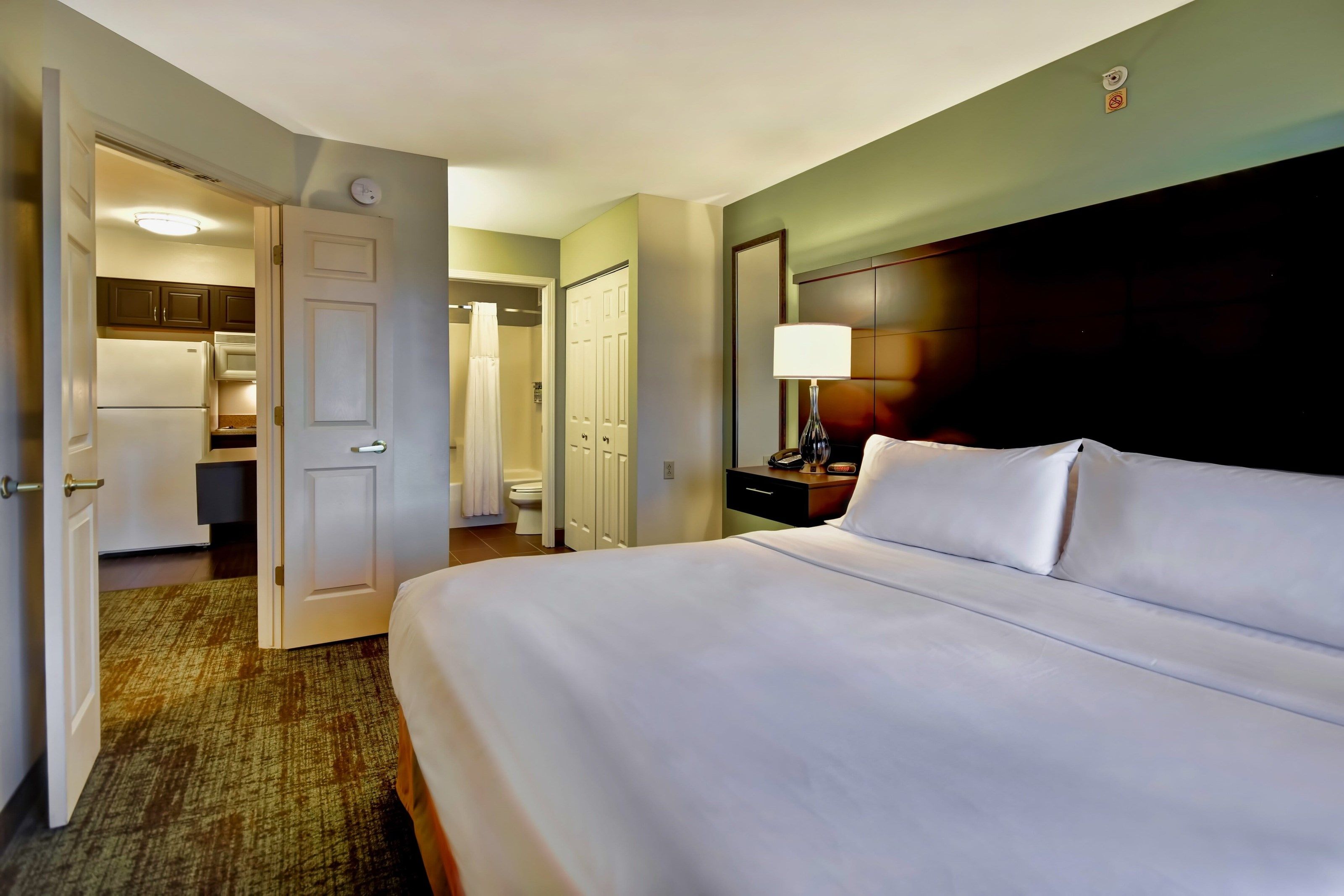 image Cozy retreat with inviting, plush bedding awaits you.