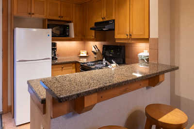 Enjoy the convenience of a modern kitchen with a breakfast bar, perfect for casual meals or snacks.