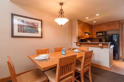 The lovely wooden dining table provides seating.