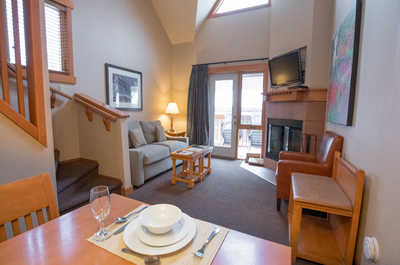 Enjoy meals in the cozy dining area, seamlessly connected to a charming living space with natural light.