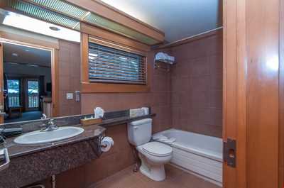This bathroom is spacious and features a shower-tub combination.