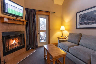 Unwind in the cozy living room, complete with a fireplace and comfortable seating for a relaxing evening.