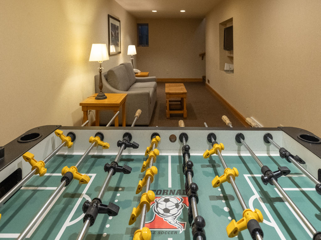 image Have fun in the recreational room, equipped with a foosball table and plenty of space to unwind.