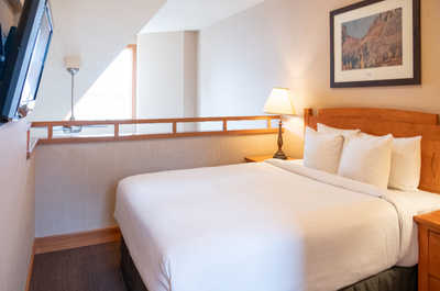 Drift off to sleep in the cozy and warm bedroom with duvets and comfortable bedding.