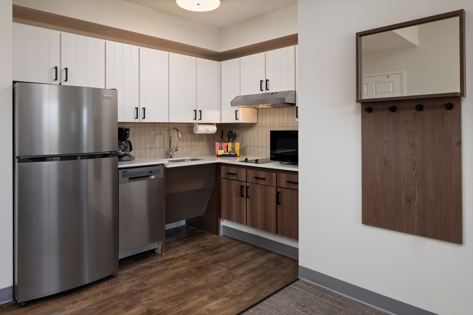 image Kitchen with refrigerator, sink, cabinets, and coffee maker.