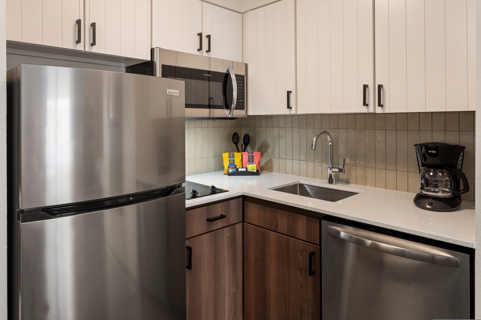 image Fully equipped kitchen with stove, dishwasher, and full-size refrigerator