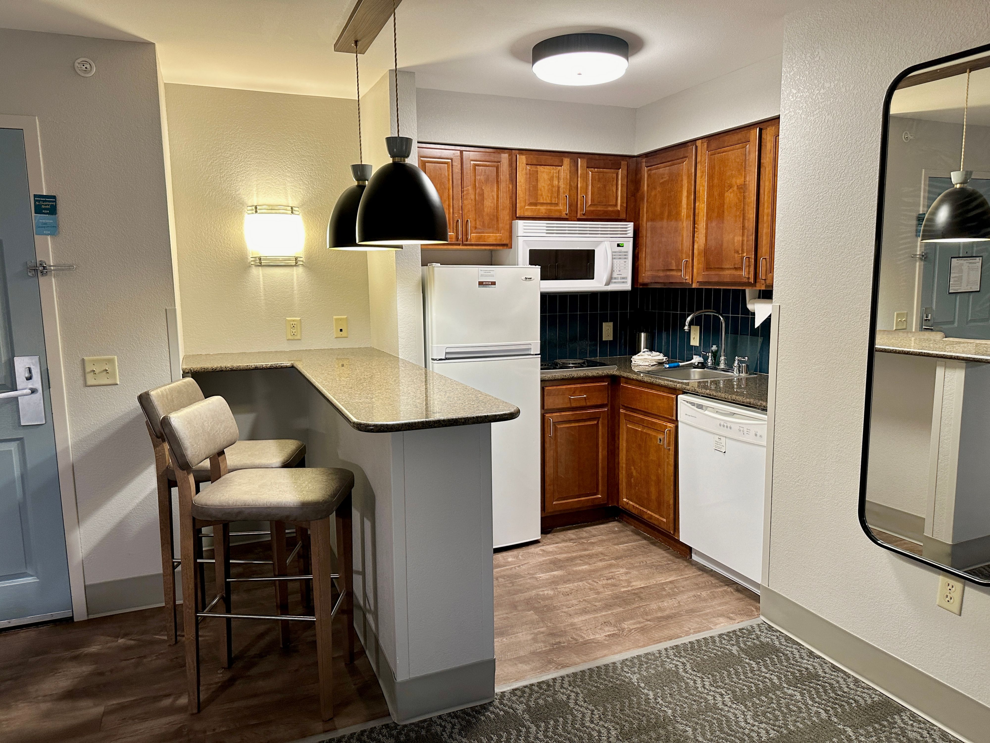 image Suite kitchen with full appliances and dining bar.