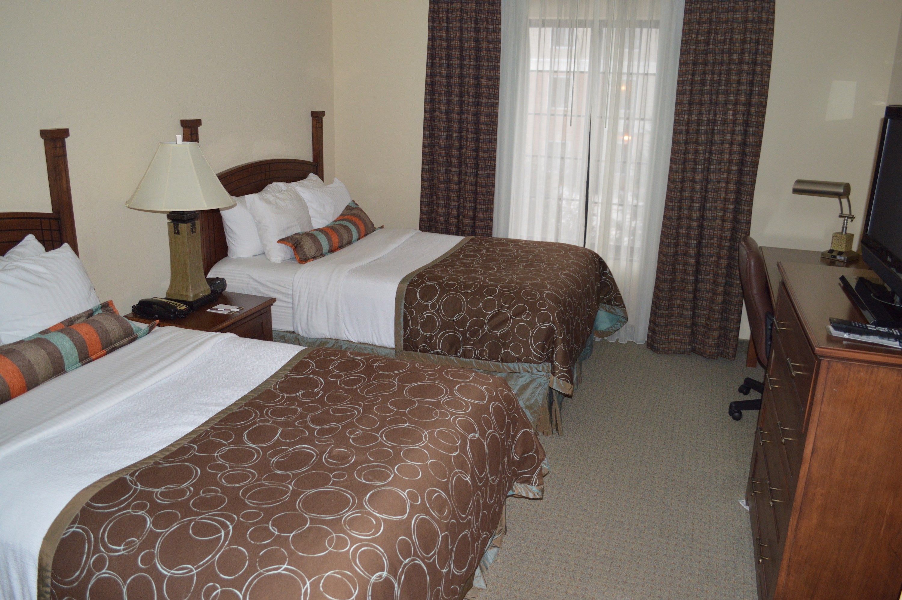 image Bedroom with two double beds and warm lighting.