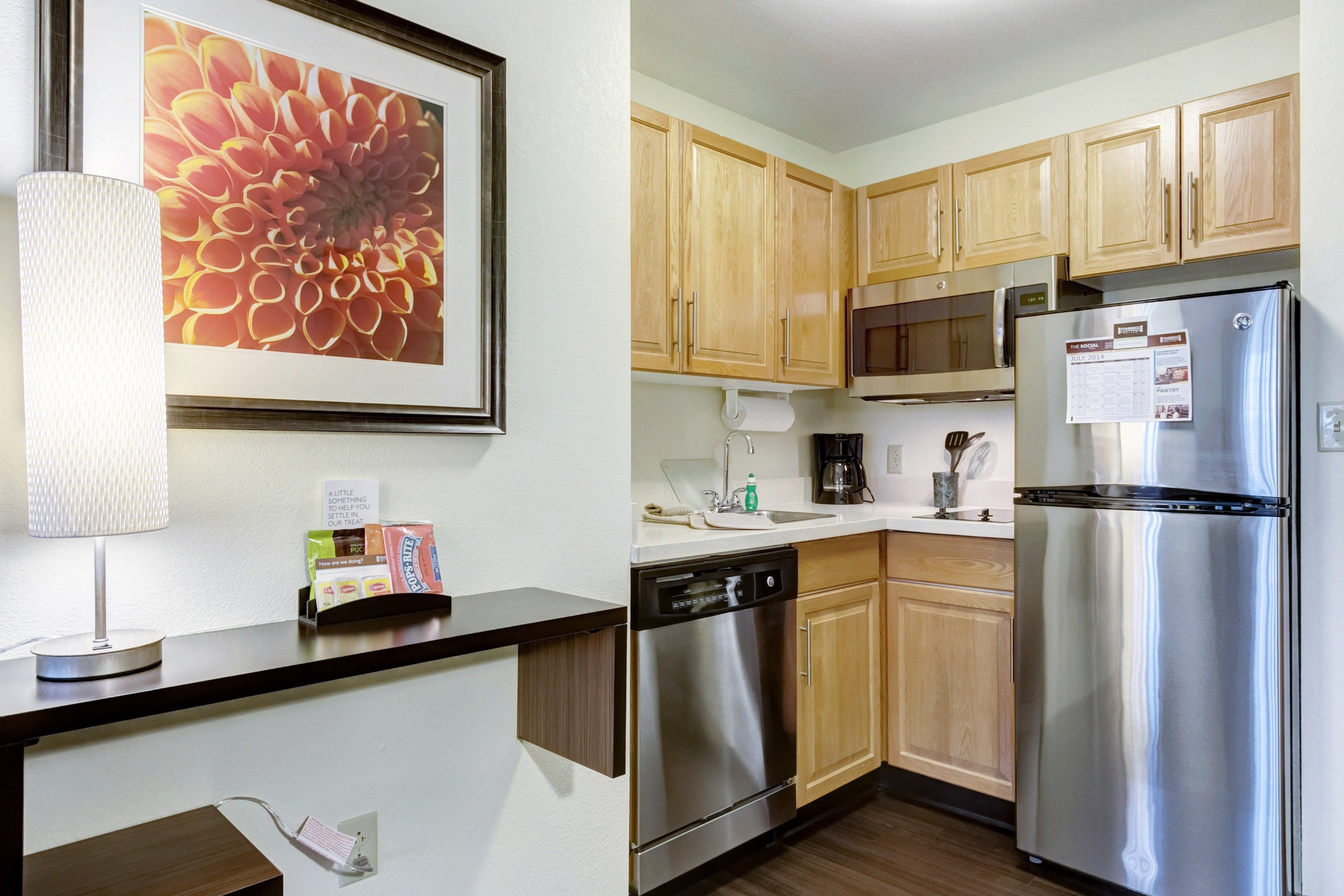 image Kitchen with wood cabinets, sink, and appliances