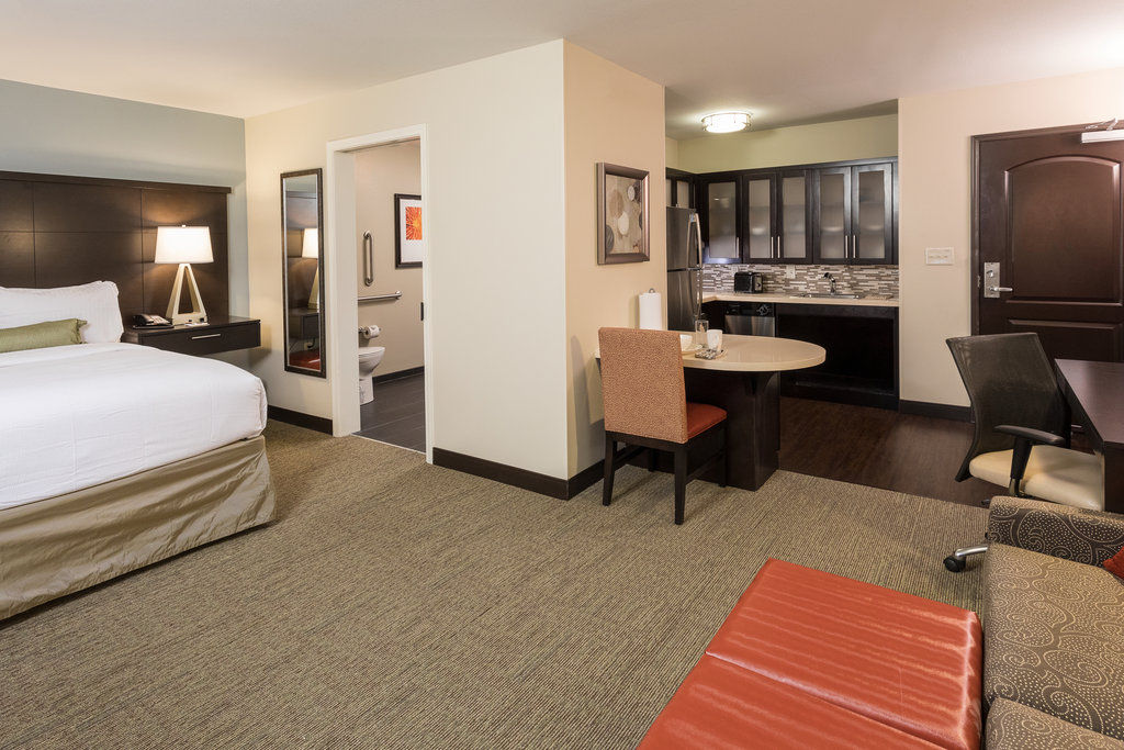 image Enjoy a cozy studio suite with a comfortable Queen bed and inviting lounge area for your stay.