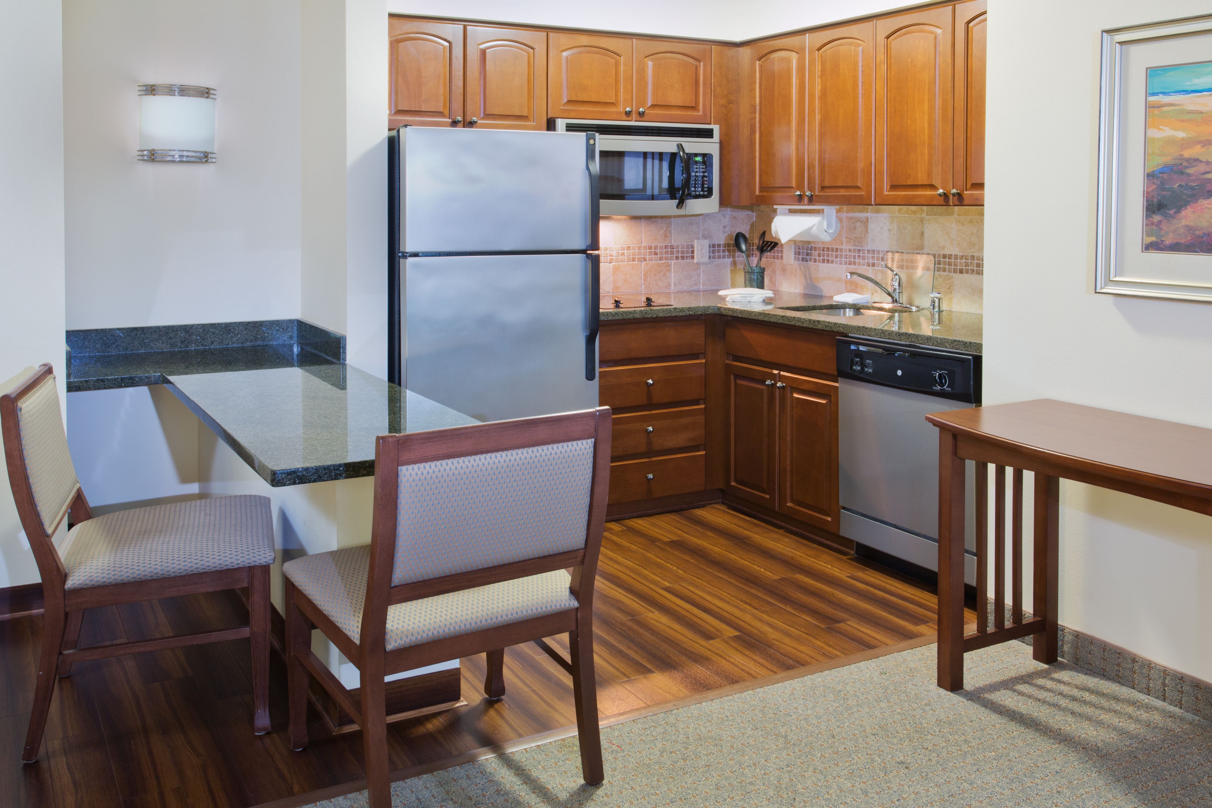 image Well-equipped kitchen with modern appliances and dining space.