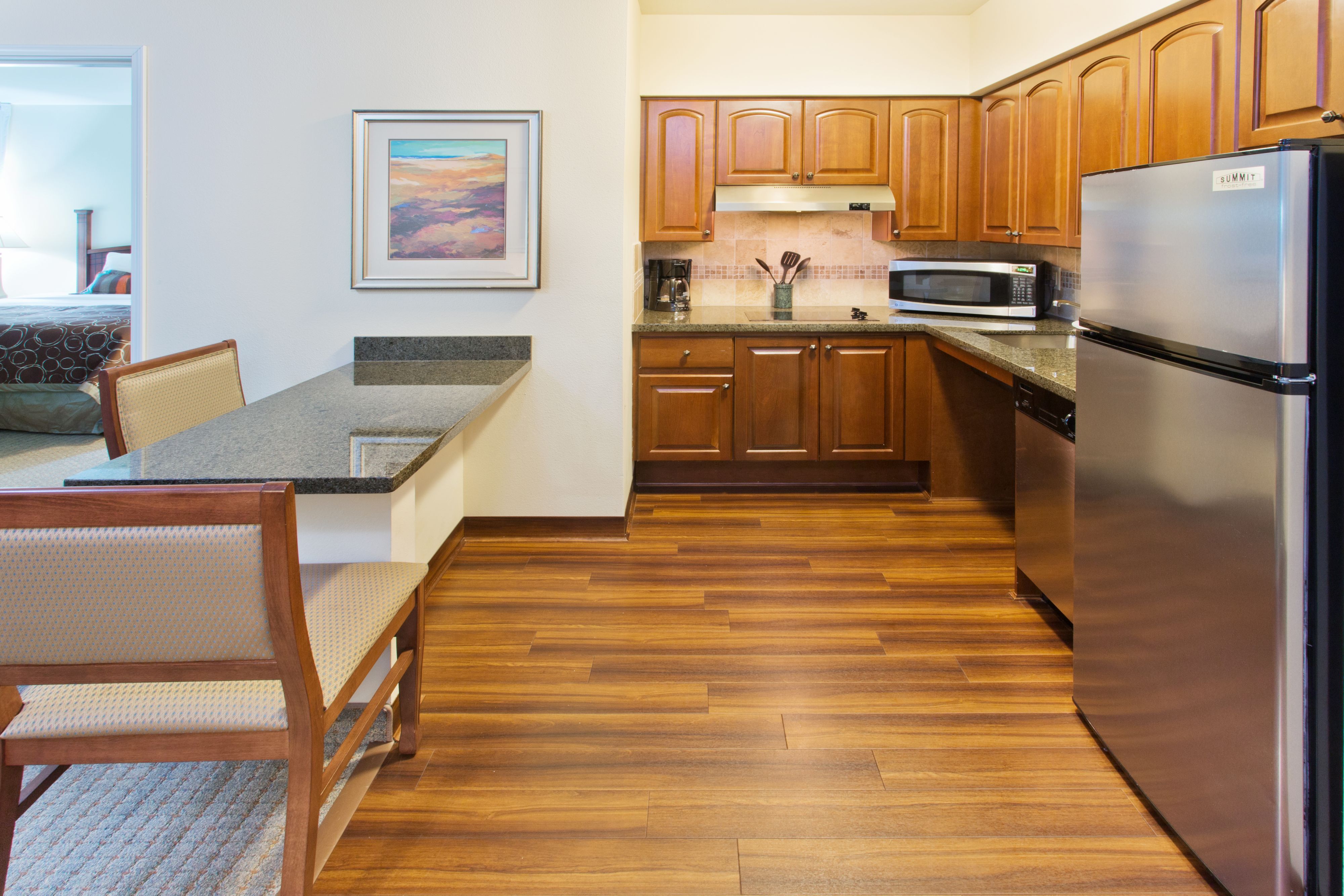 image Functional kitchen area with modern appliances and seating.