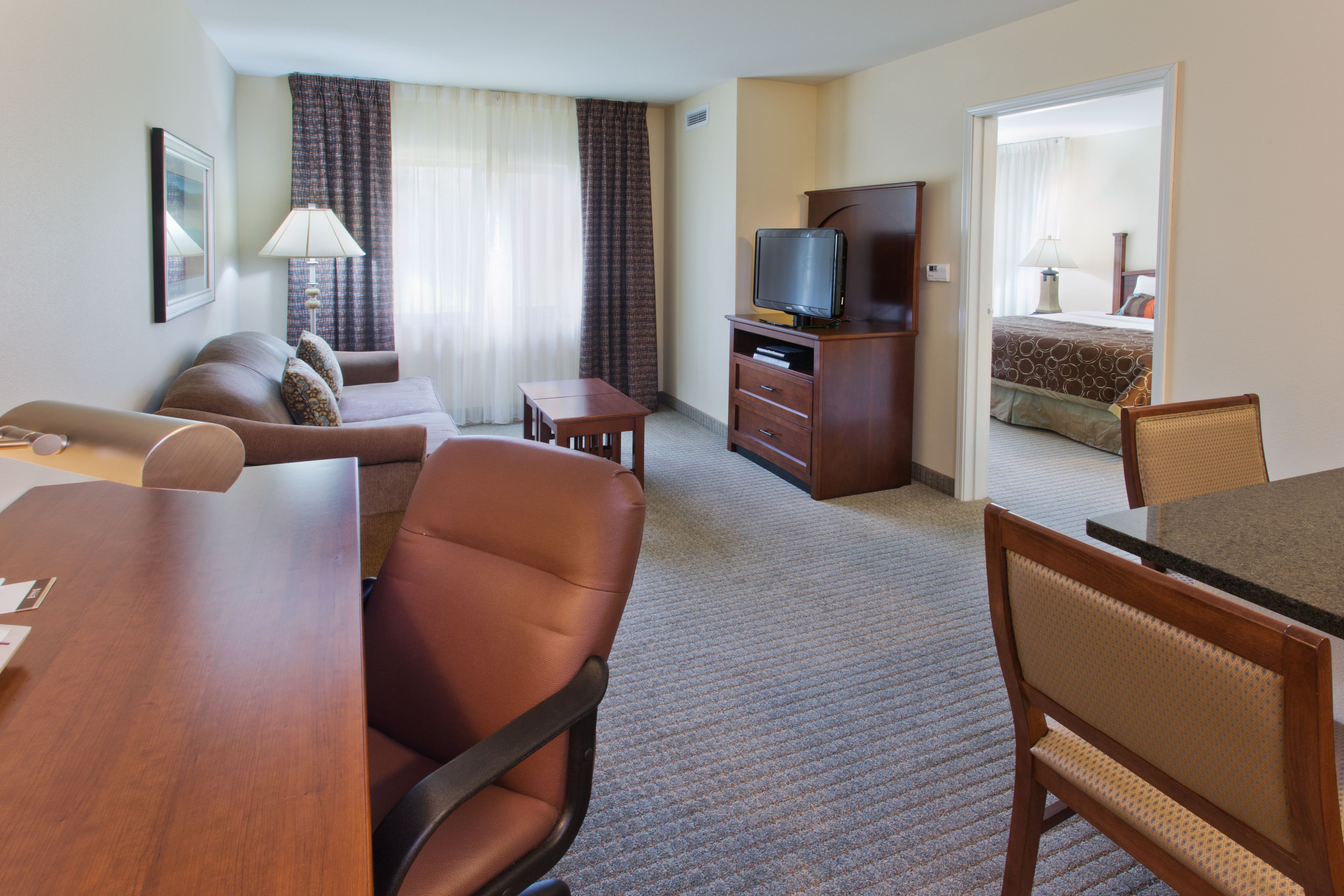 image Spacious room with a work desk and bright windows.