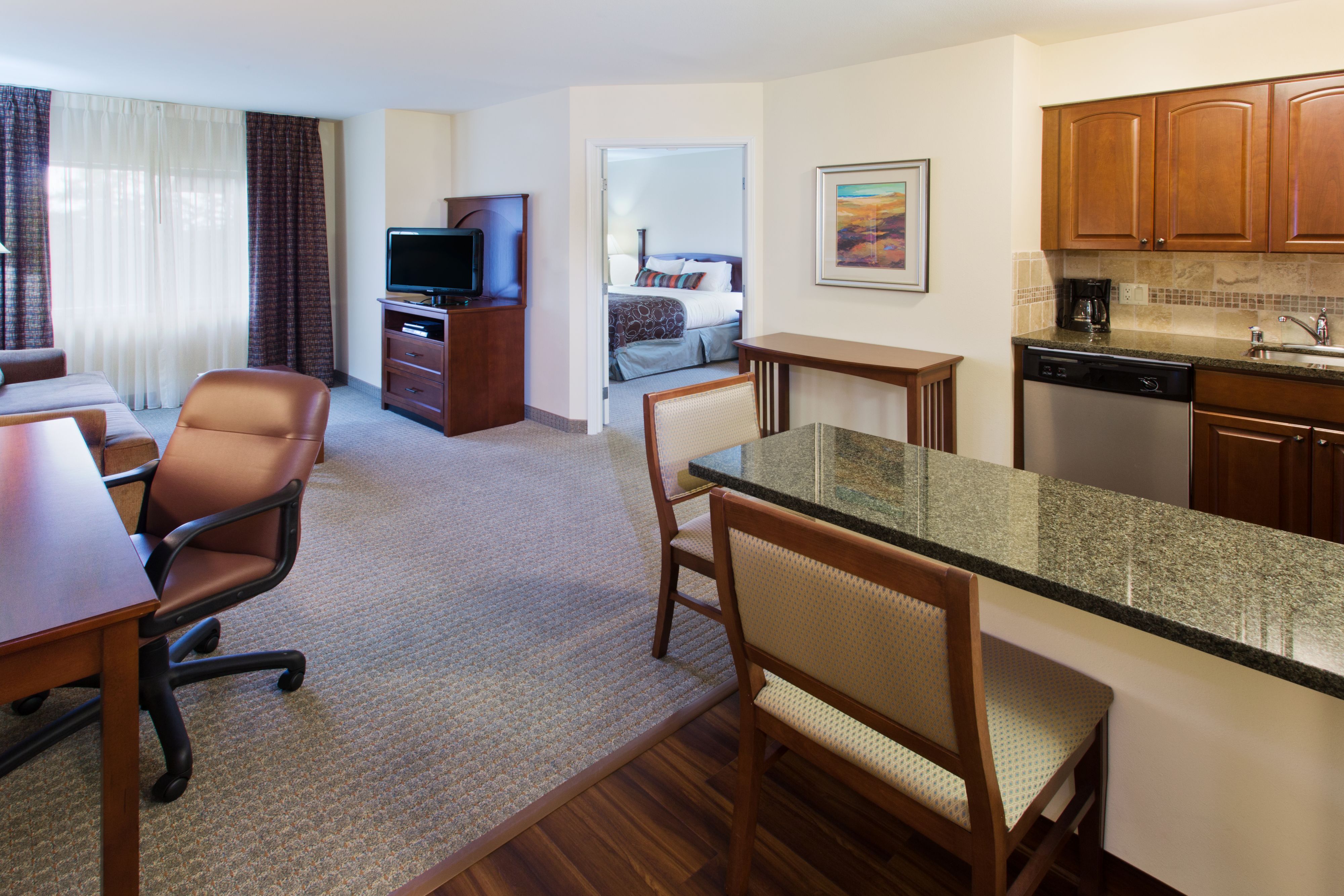image Spacious living area with comfortable seating and kitchen amenities.