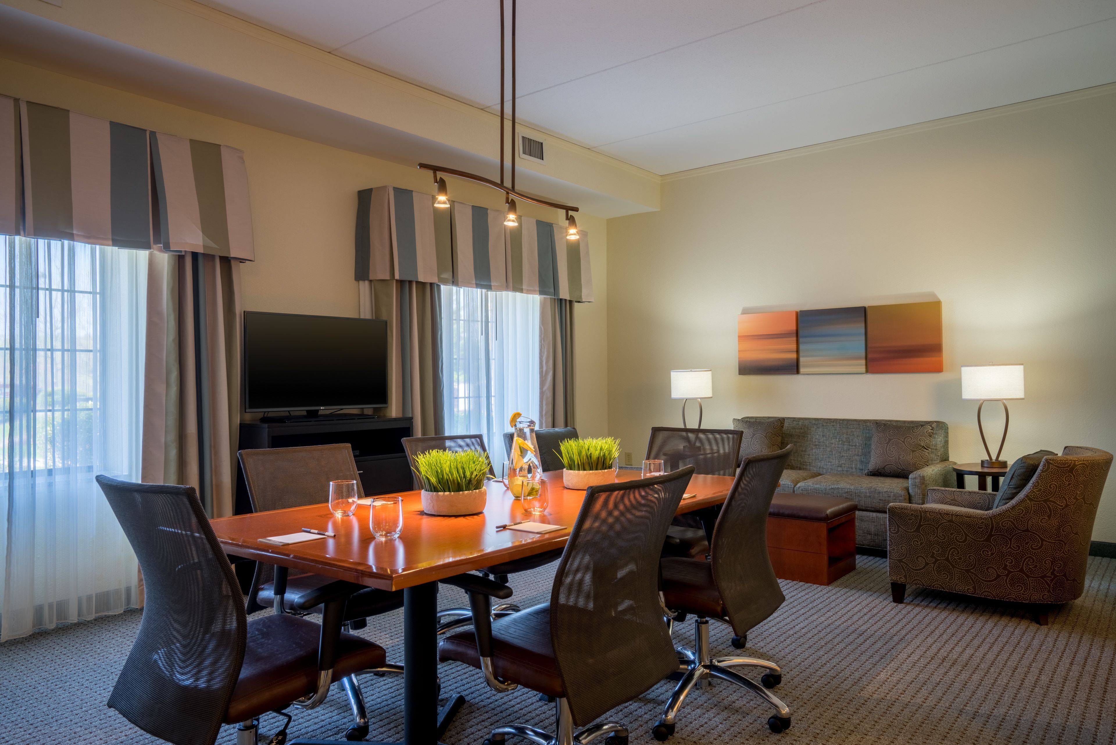 image Conference and dining area with large table and chairs.