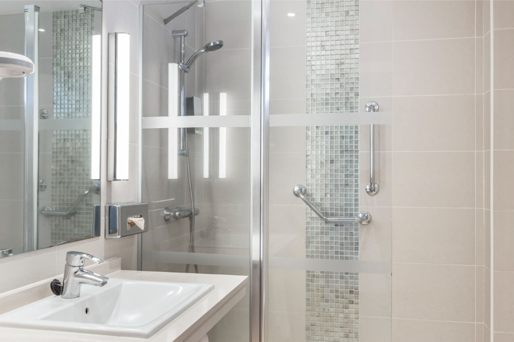 image Bright and airy bathroom with a glass-enclosed shower, combining modern design with clean lines.