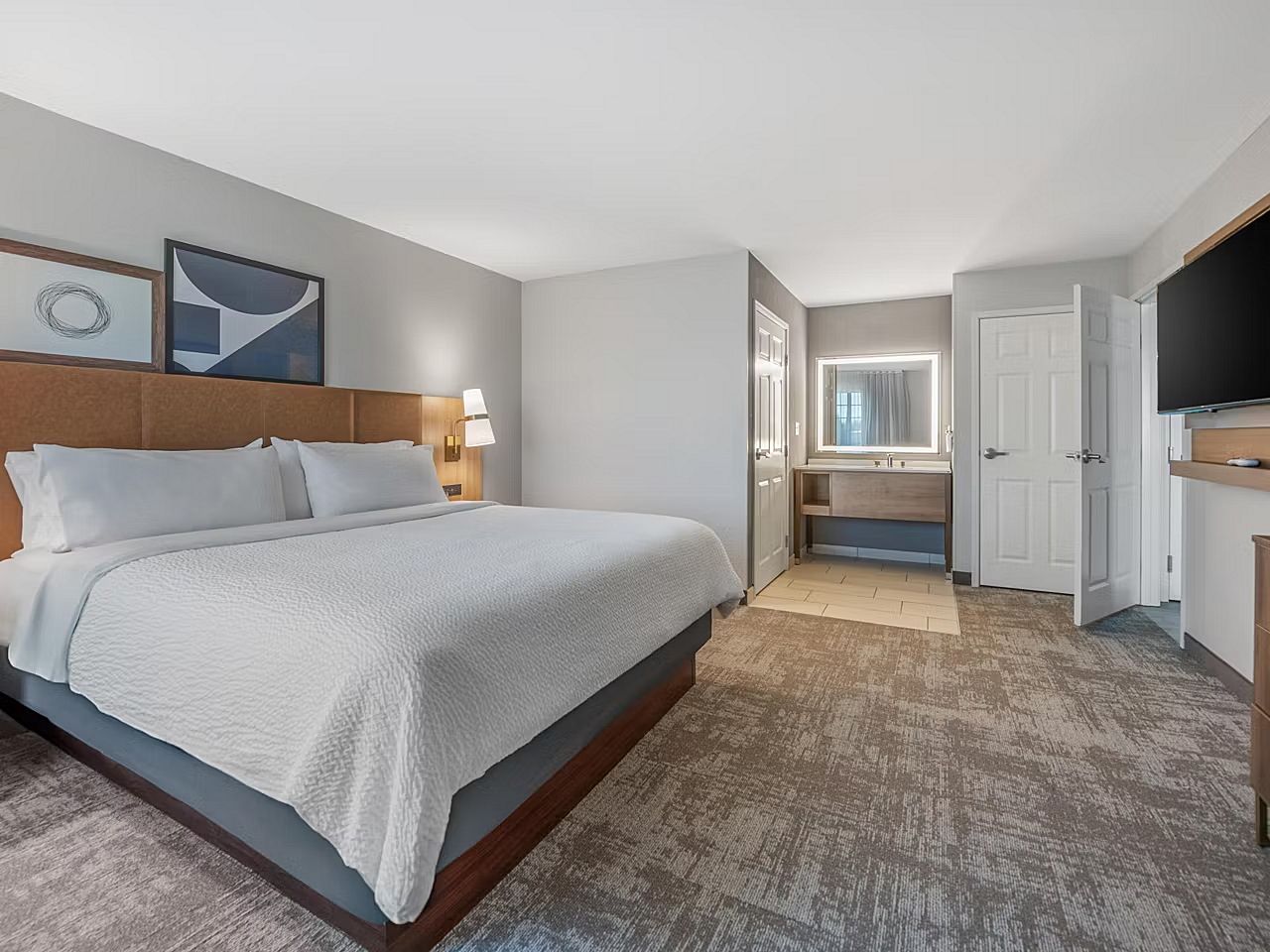image Drift into relaxation on the plush king bed, perfect for restful nights after busy days.