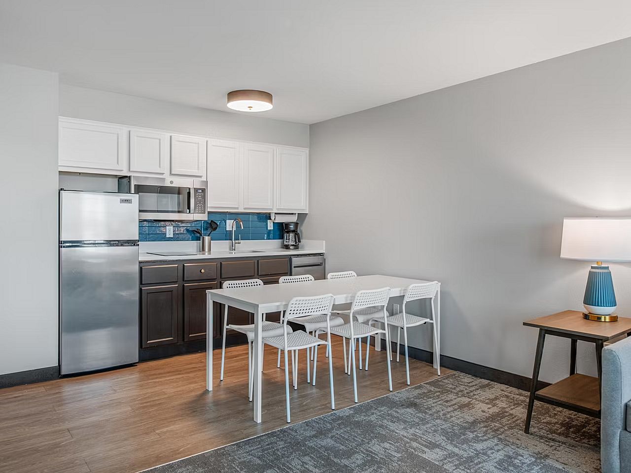 image Cook up your favorite meals in a sleek, fully-equipped kitchen with a cozy dining area.