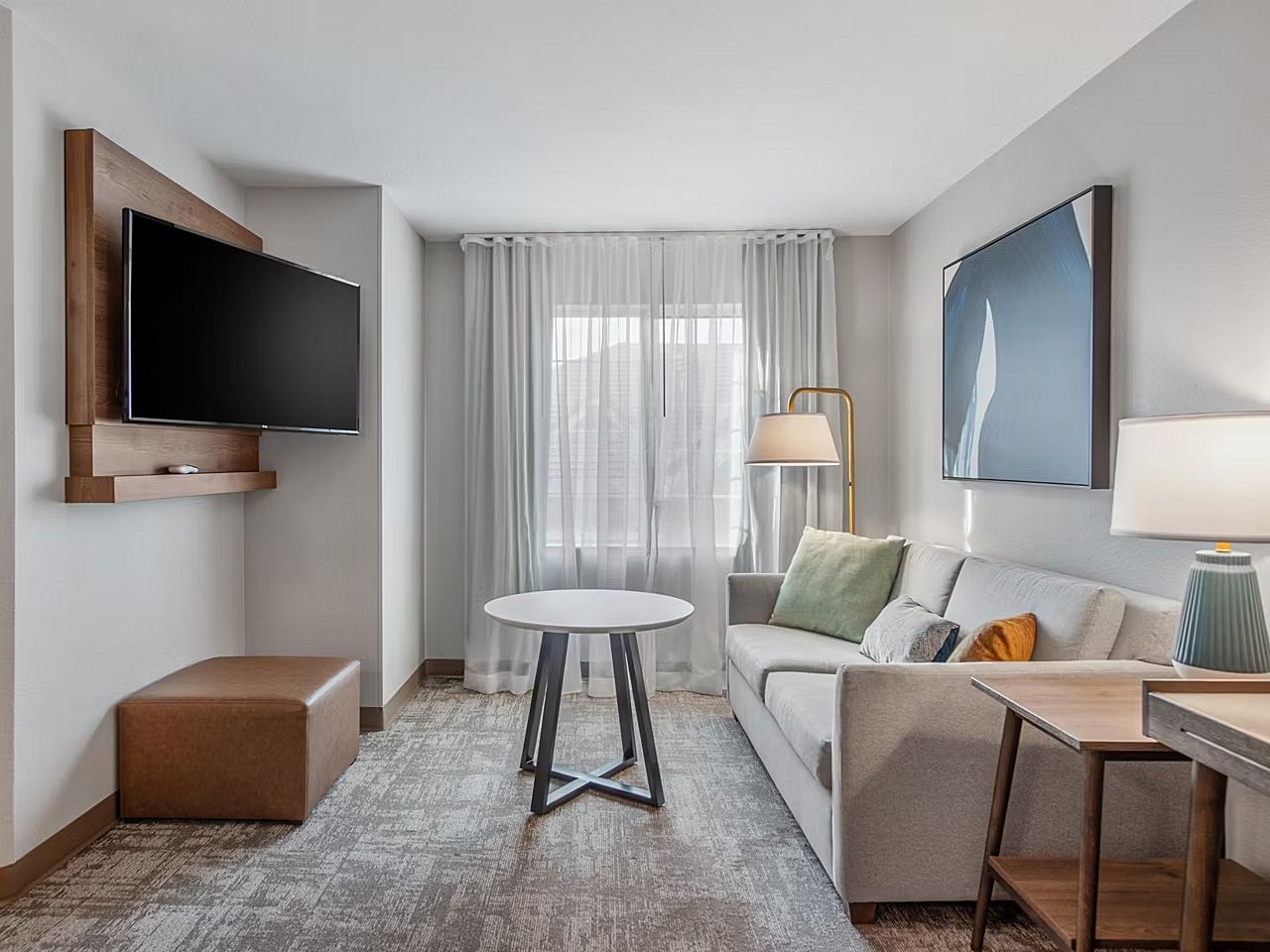 image Relax in this inviting living area with a cozy couch and sleek decor, perfect for unwinding after a day of adventures.