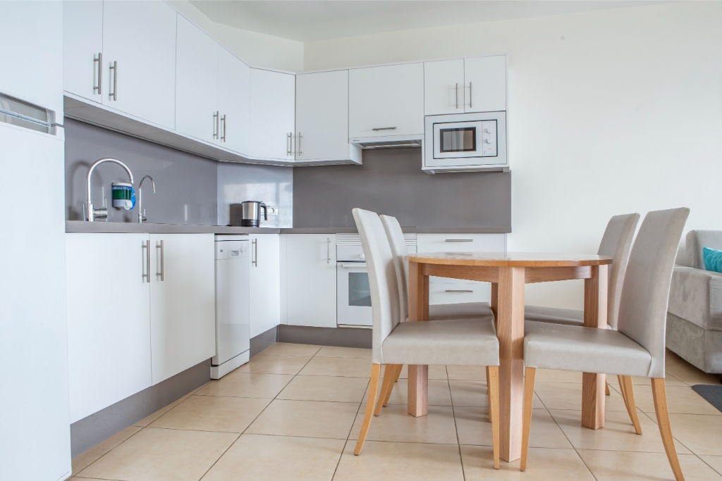 image Functional dining area adjacent to the kitchen, a perfect spot for family meals and socializing.