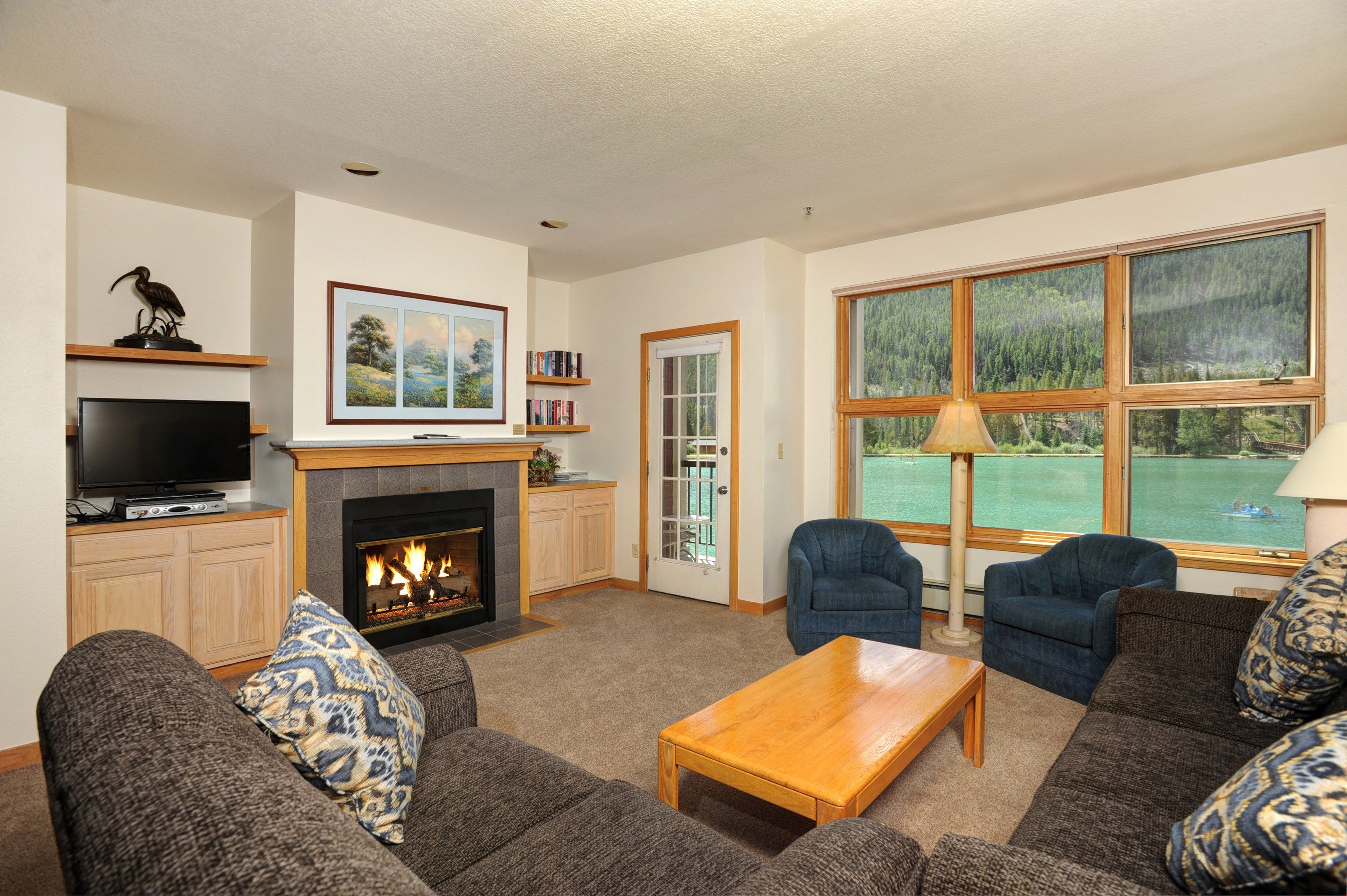 image Relax in the cozy living area, complete with fireplace and TV