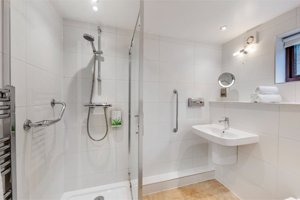image Modern bathroom with walk-in shower for a refreshing start to the day.