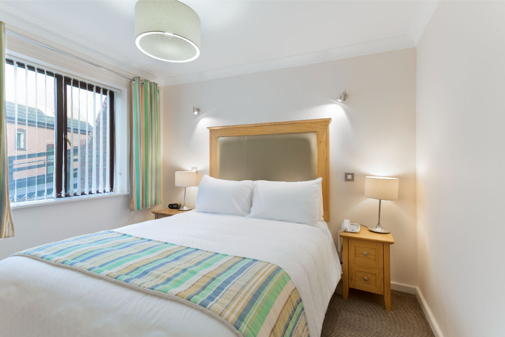 image Restful bedroom with fresh linens for a peaceful night's sleep.