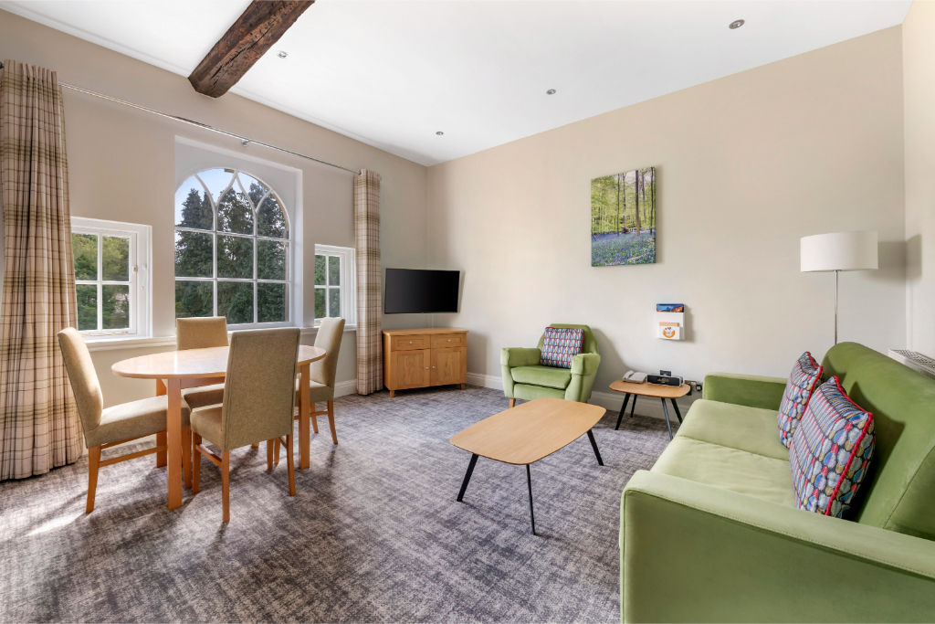image Bright dining and living area with comfortable seating.