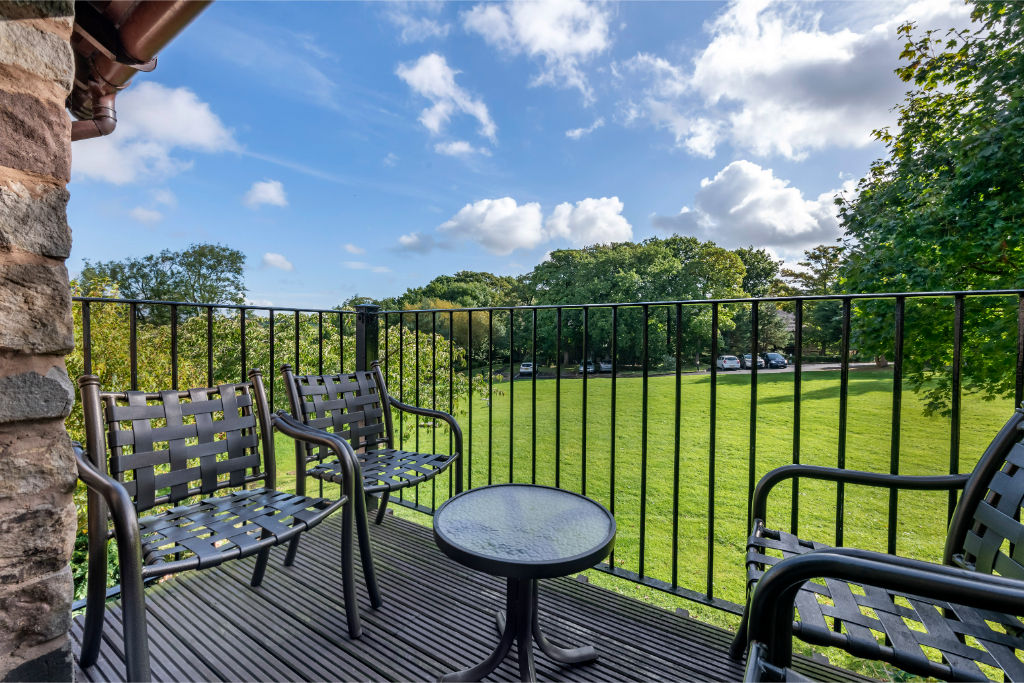 image Patio with outdoor seating overlooking green fields.