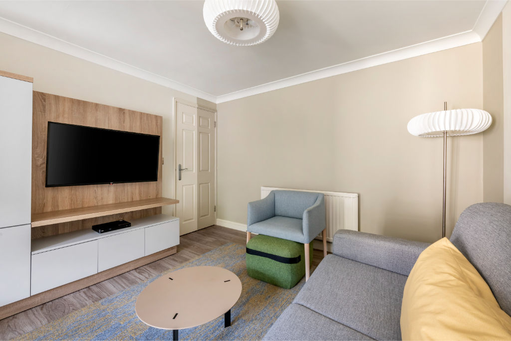 image A cozy living space with comfortable seating and a convenient setup for relaxation or entertainment.
