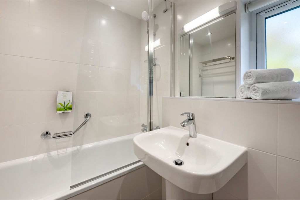 image A modern and clean bathroom equipped with a full bathtub and a bright, welcoming design.