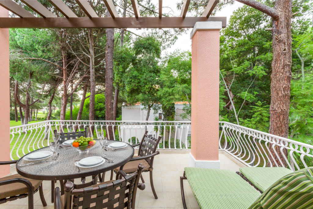 image Outdoor patio dining set in a verdant environment.