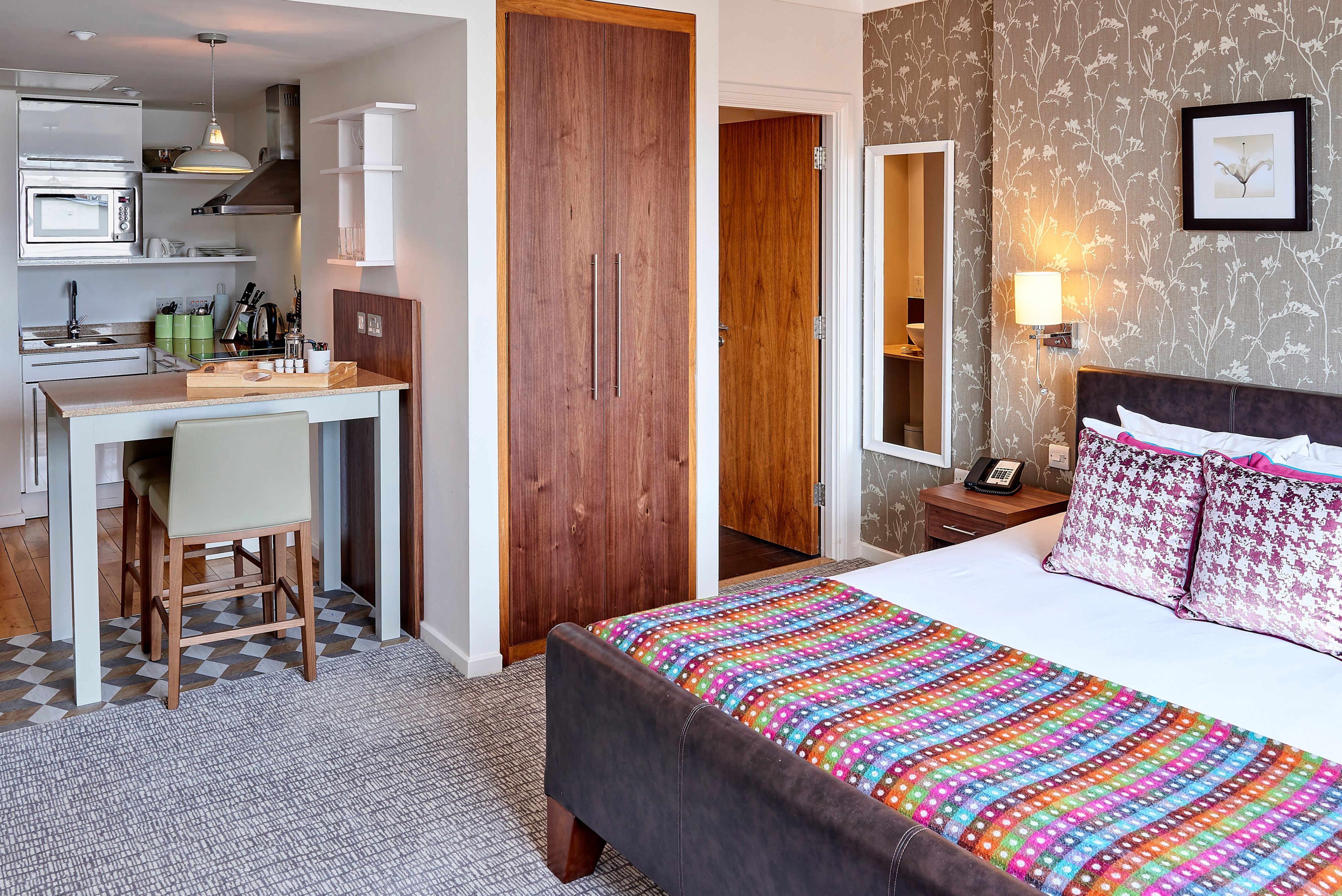 image Open studio suite with king bed, kitchen, and dining area.