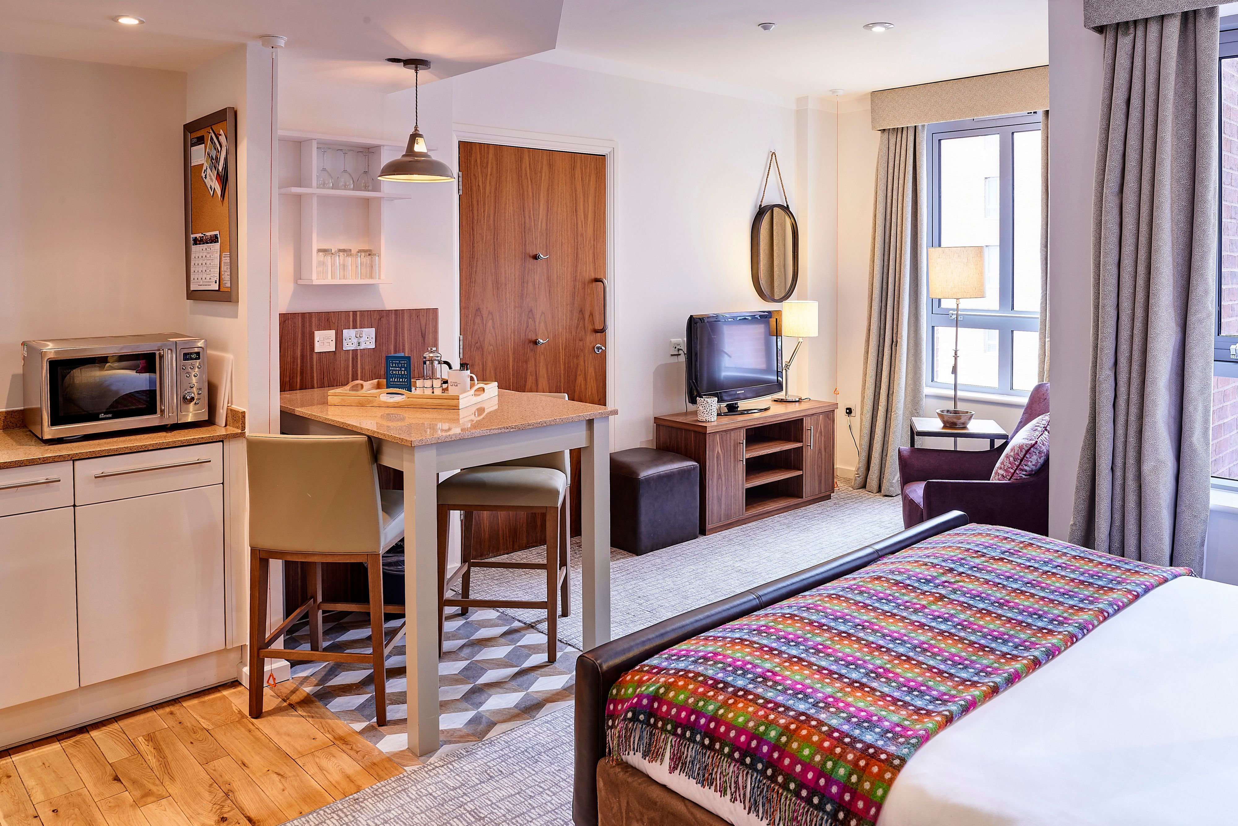 image Accessible studio suite with kitchen, dining area, and comfortable layout.